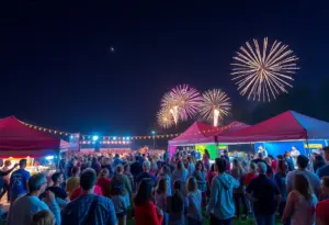 Community members enjoying the Rockin' 4 Heroes benefit concert with fireworks in the background.