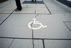 A damaged sidewalk in Tucson affecting accessibility for pedestrians.