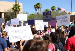 Crowd of protesters in Tucson holding democratic signs